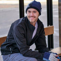 man sitting on bench wearing a wool beanie hat and fingerless gloves from baabaazuzu