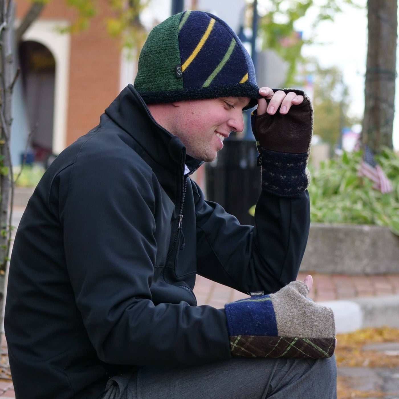 man wearing beanie hat and fingerless gloves outside