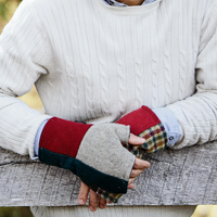 man leaning on fence wearing wool fingerless gloves