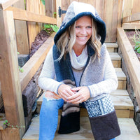 woman smiling wearing a fleece lined hoodie scarf with pockets